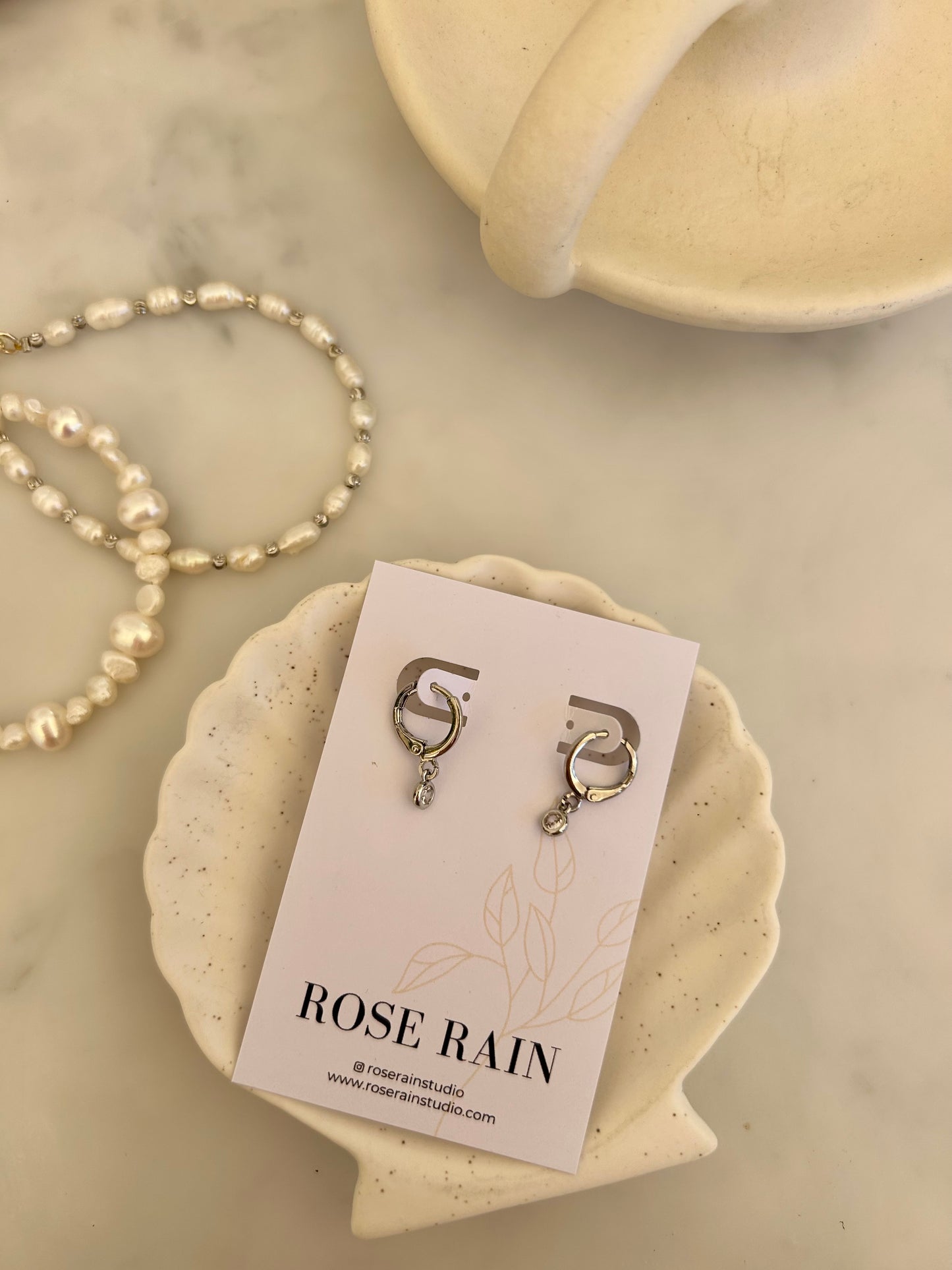 TINY DROP HUGGIE EARRINGS IN PLATINUM