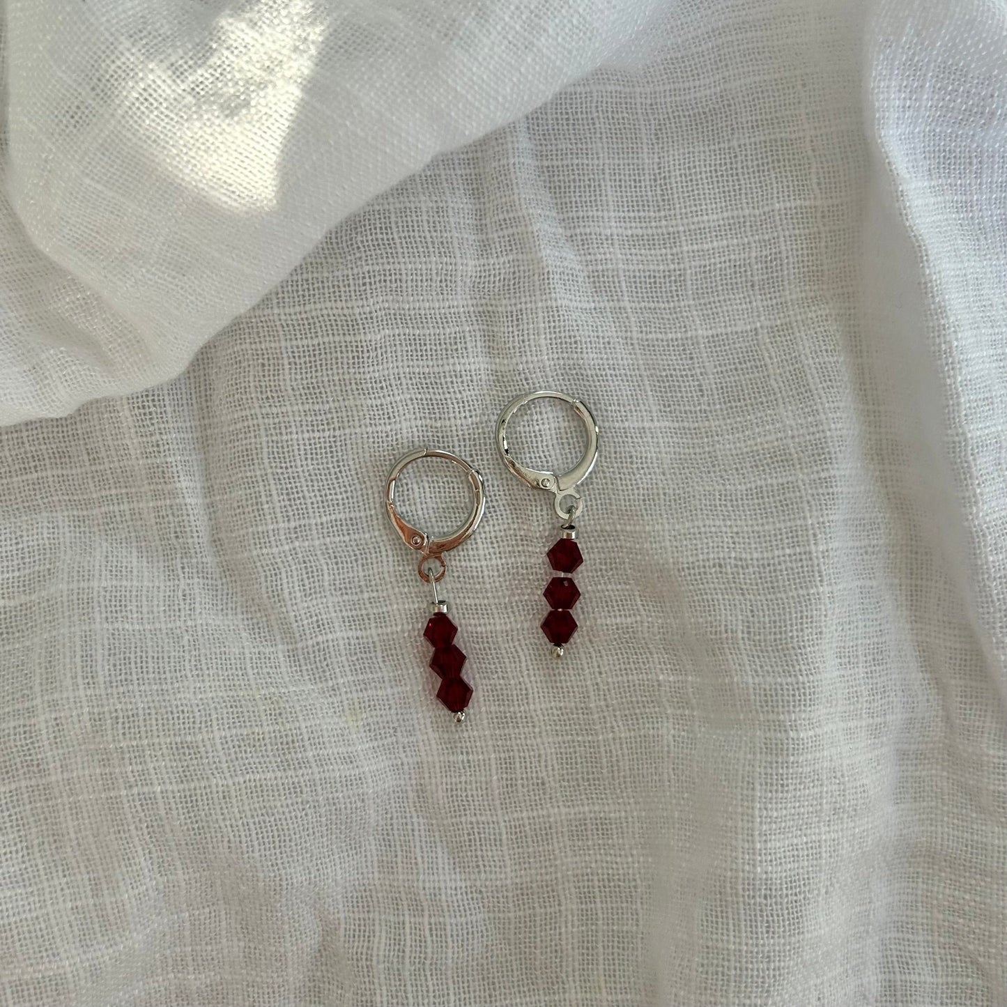 MILLIE RED HUGGIE EARRINGS IN PLATINUM