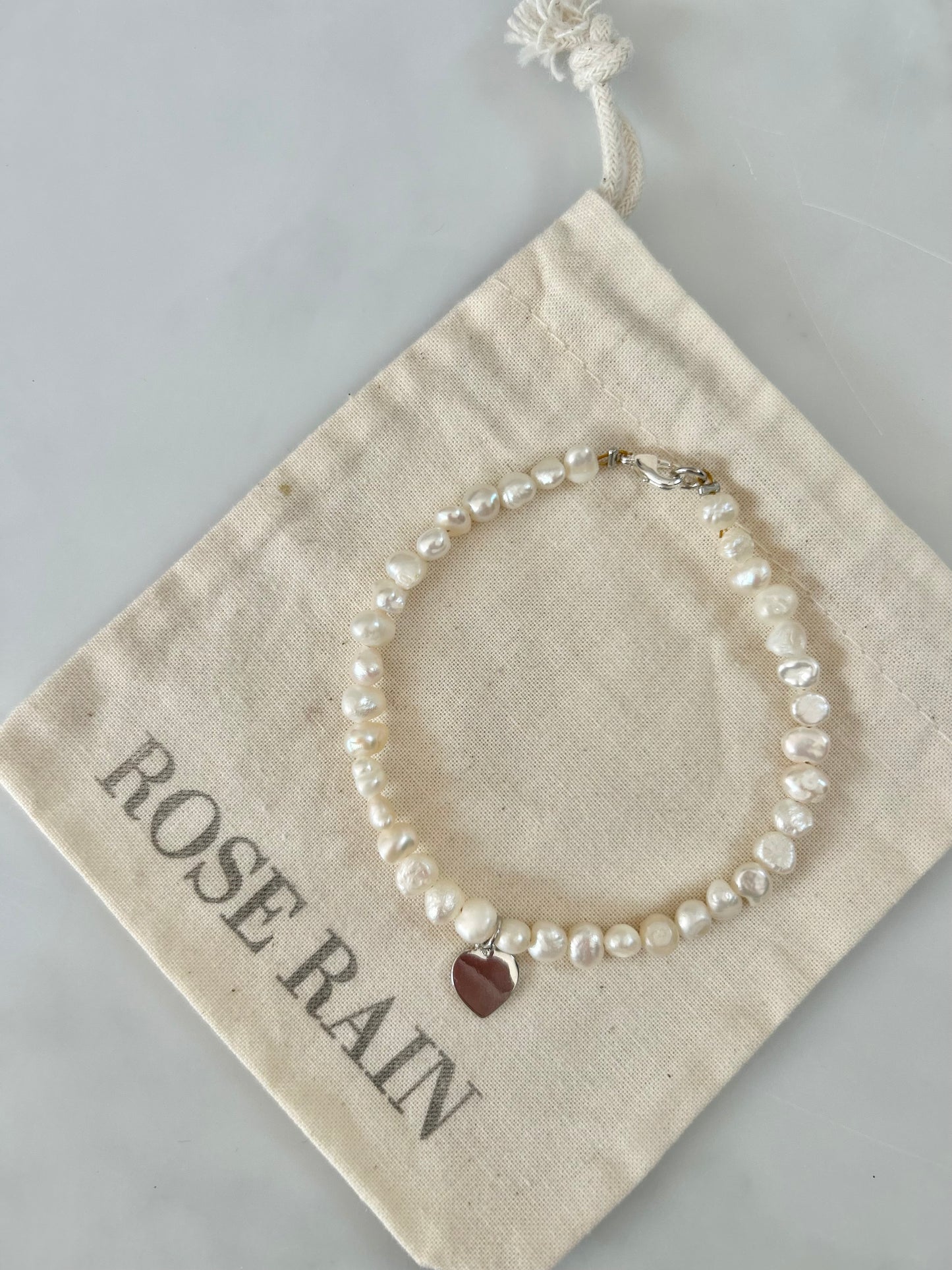 FRESHWATER PEARL HEART CHARM BRACELET IN PLATINUM
