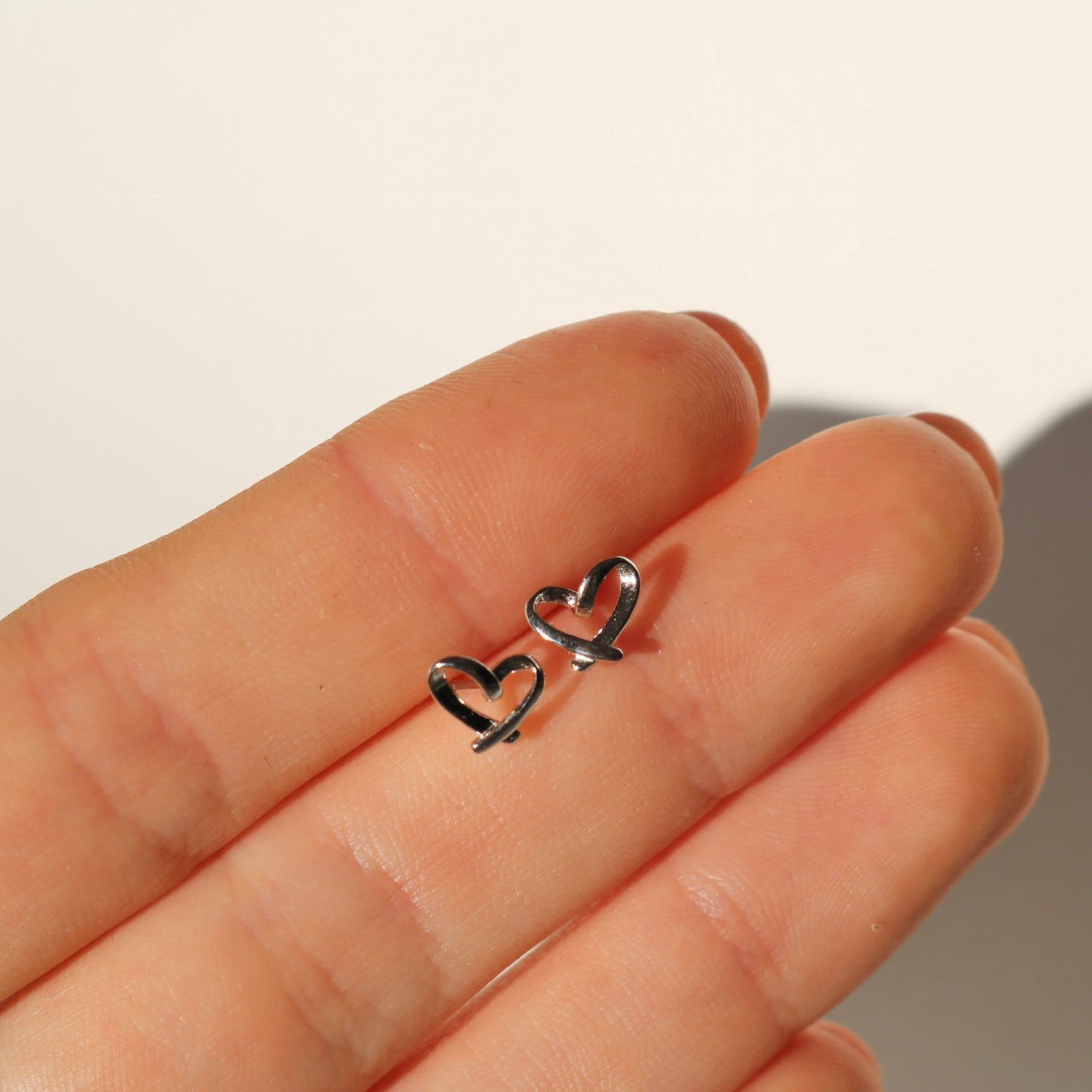 HEART OUTLINE STUD EARRINGS IN PLATINUM