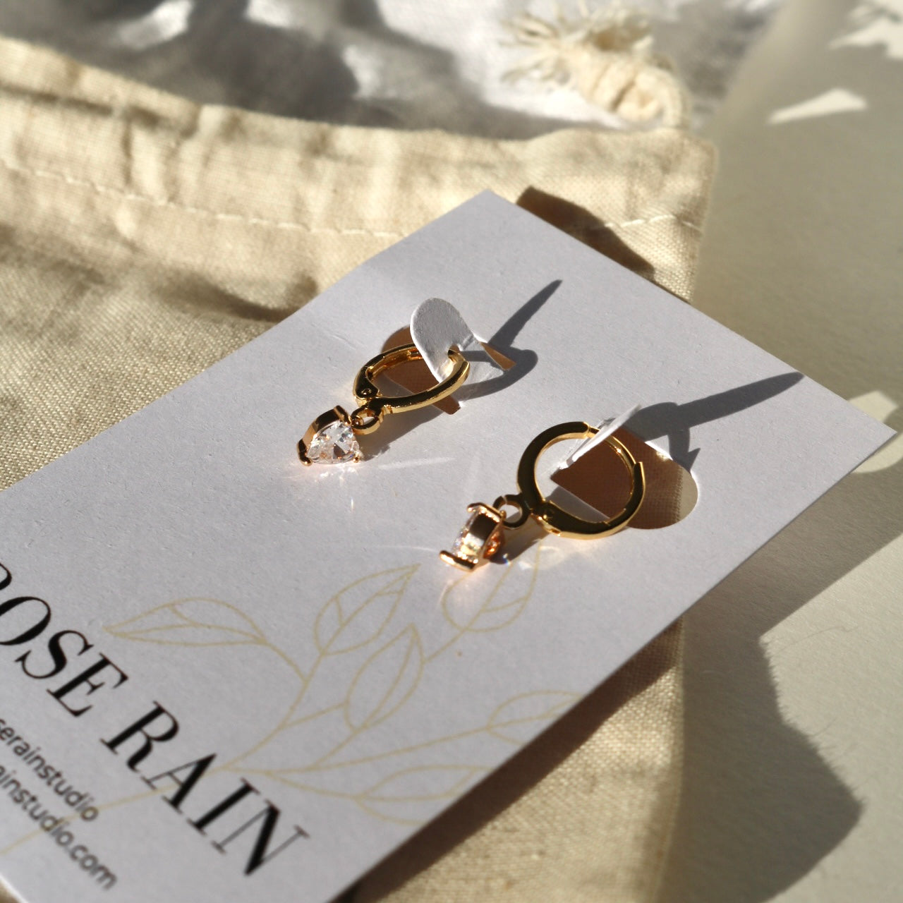 TINY HEART HUGGIE EARRINGS IN 18K GOLD