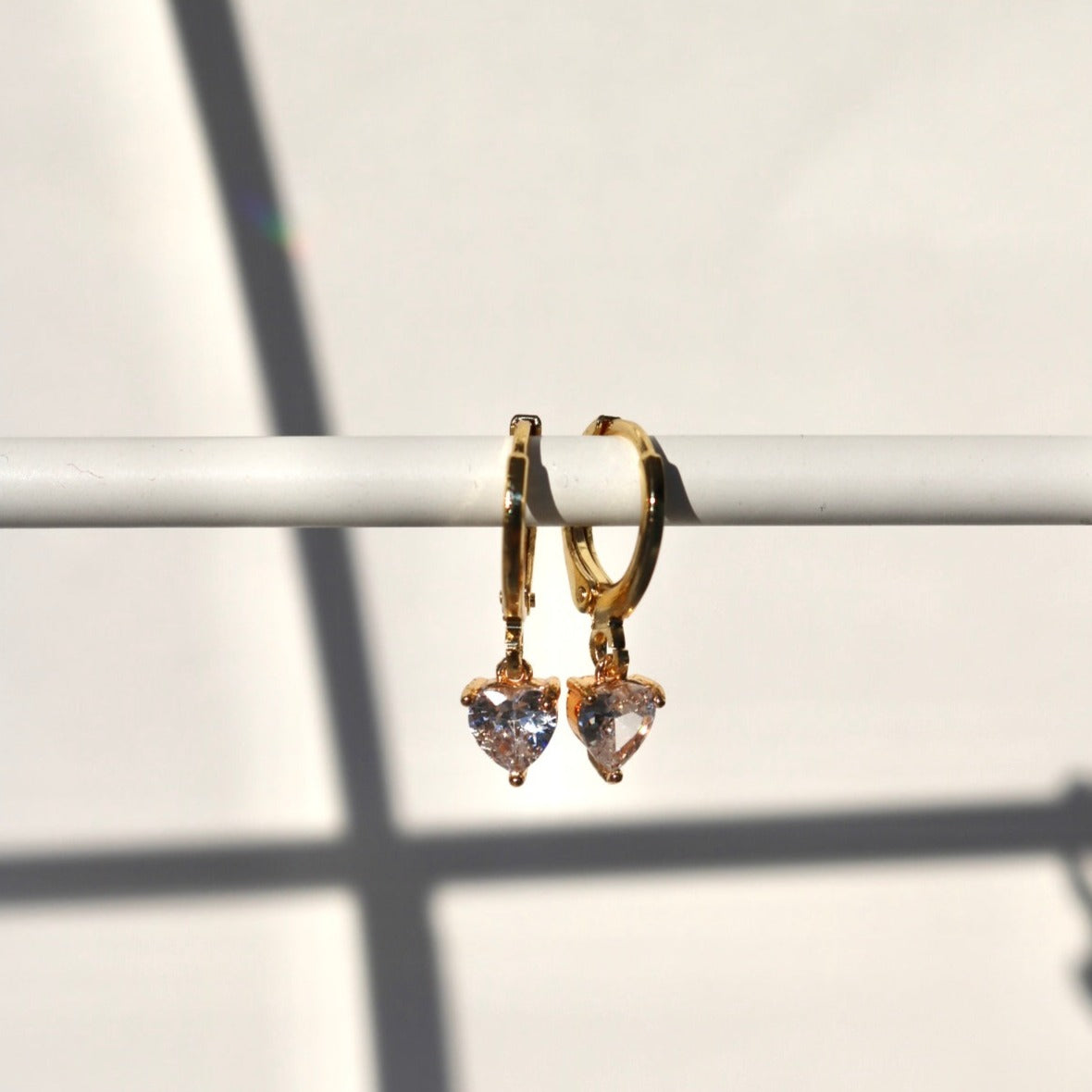 TINY HEART HUGGIE EARRINGS IN 18K GOLD