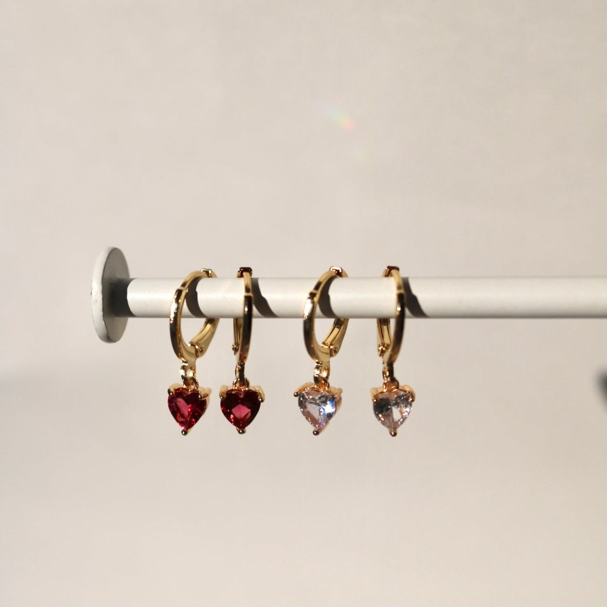 TINY HEART HUGGIE EARRINGS IN 18K GOLD