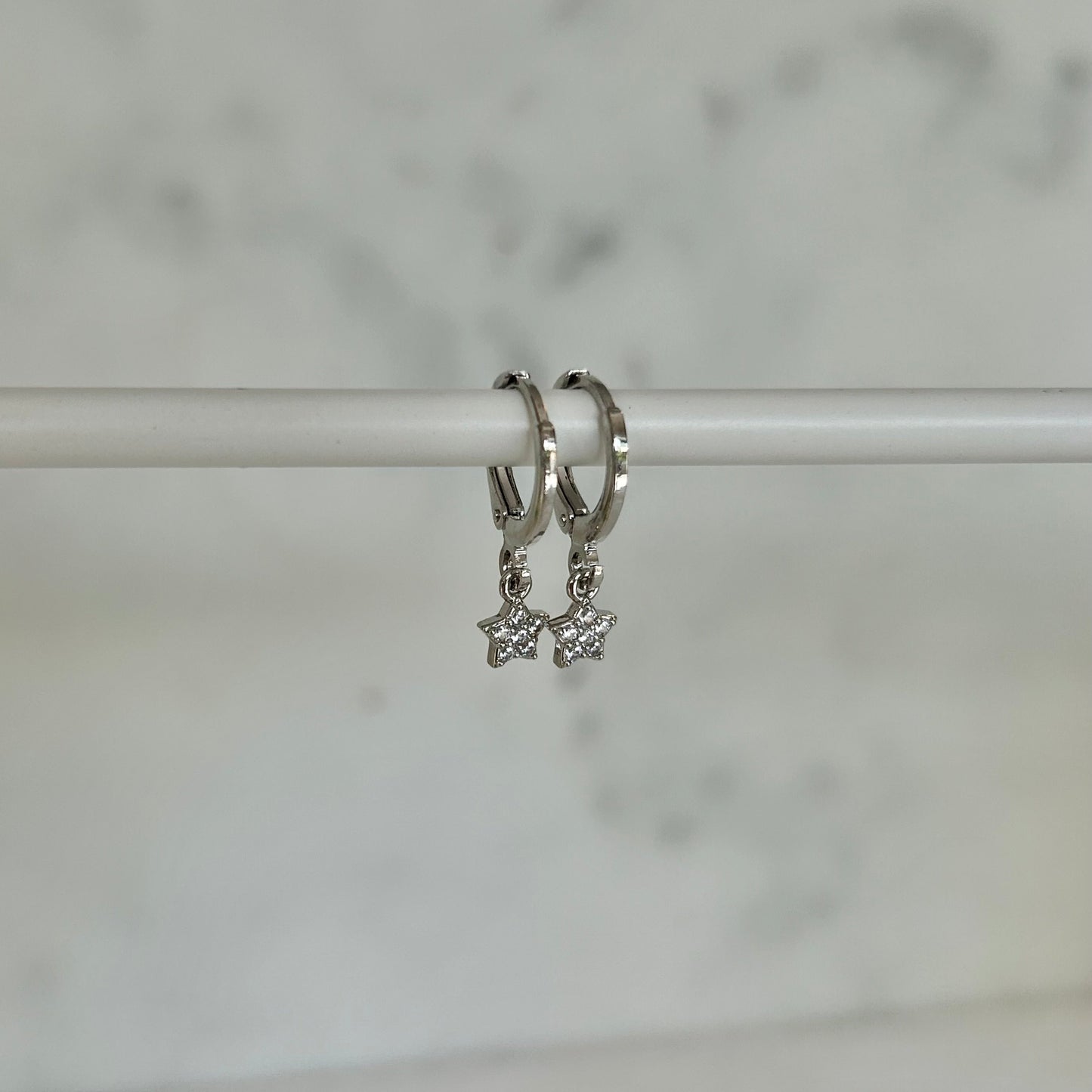 TINY STAR HUGGIE EARRINGS IN PLATINUM