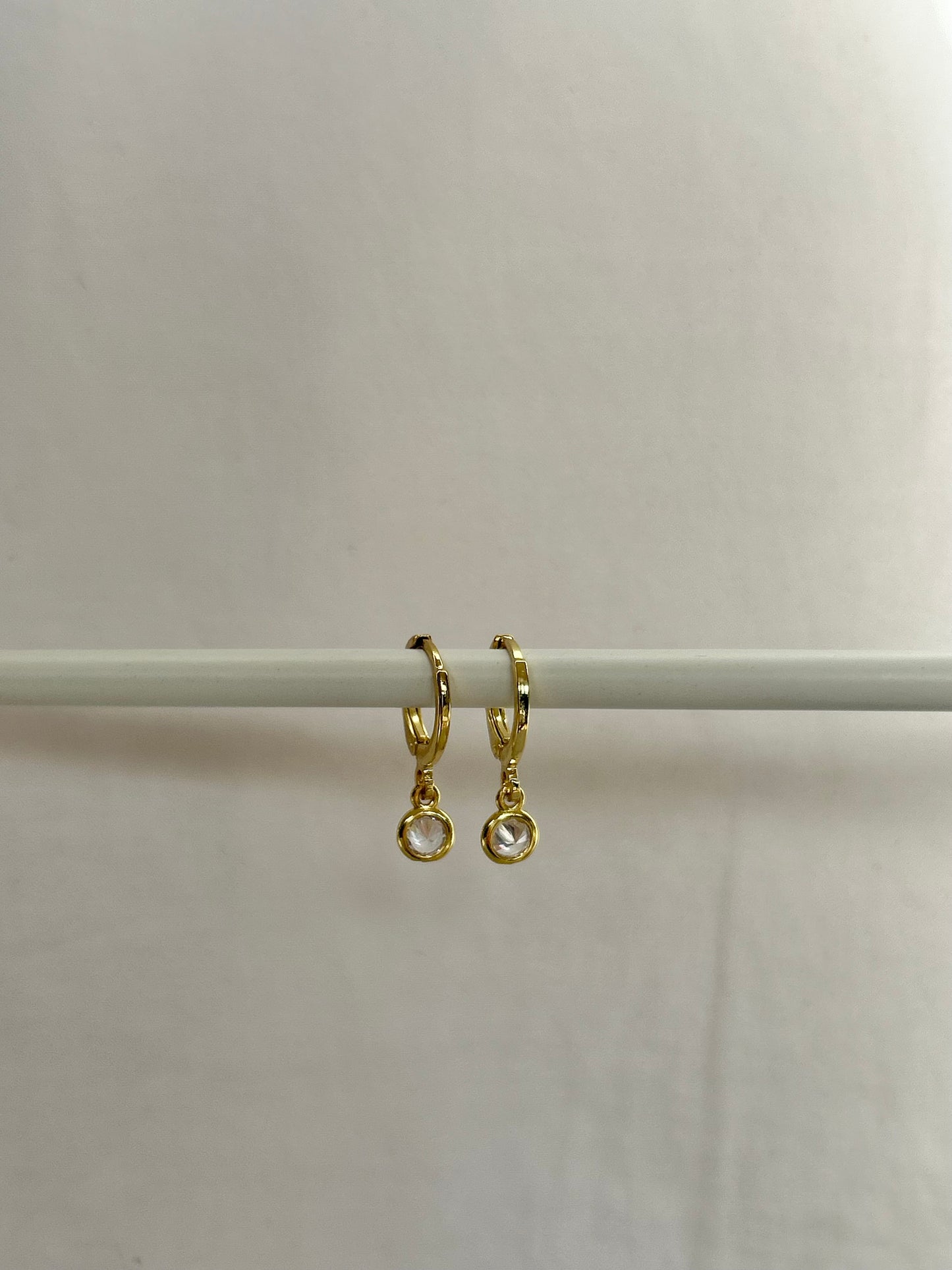TINY DROP HUGGIE EARRINGS IN 18K GOLD