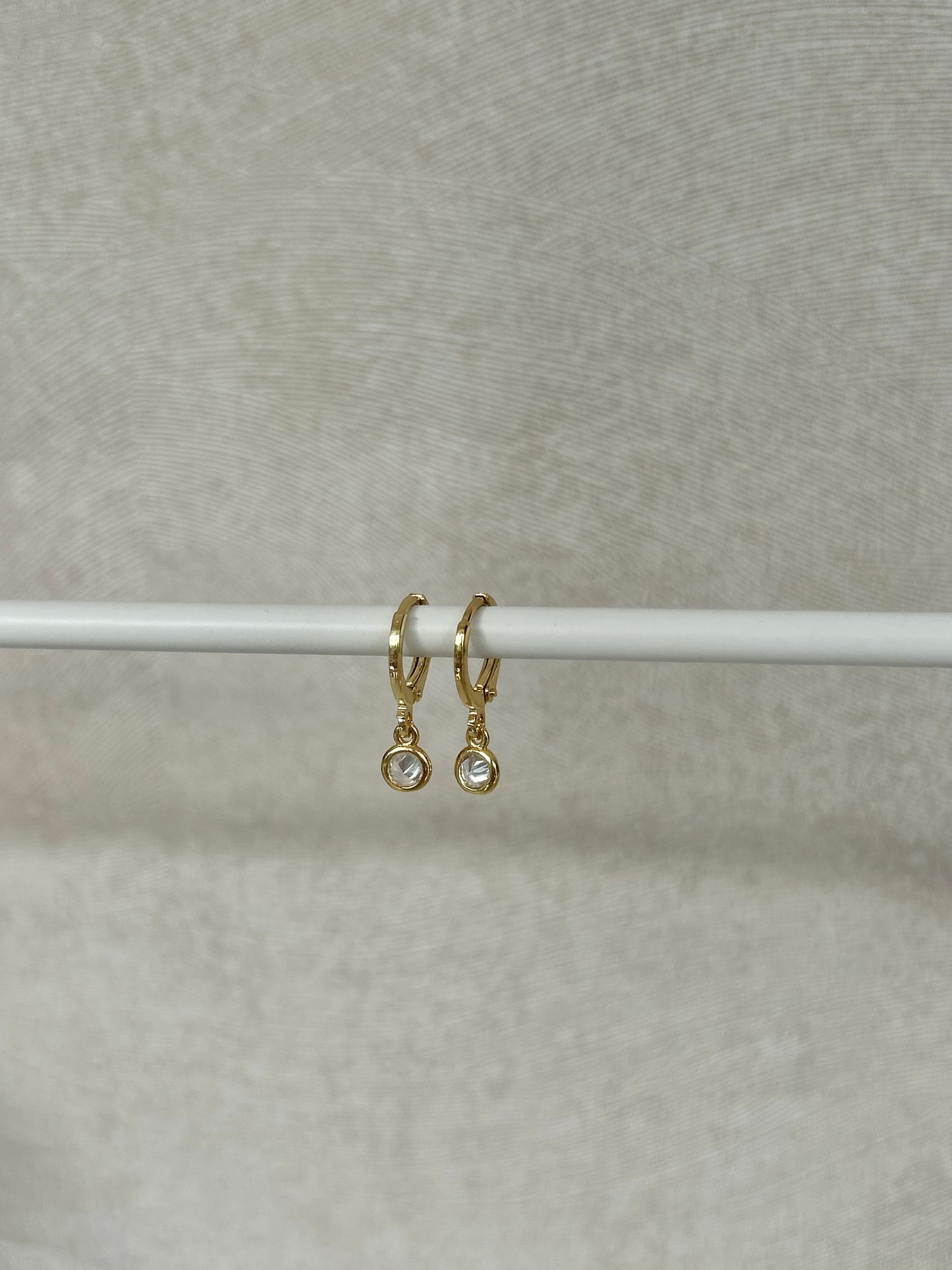 TINY DROP HUGGIE EARRINGS IN 18K GOLD