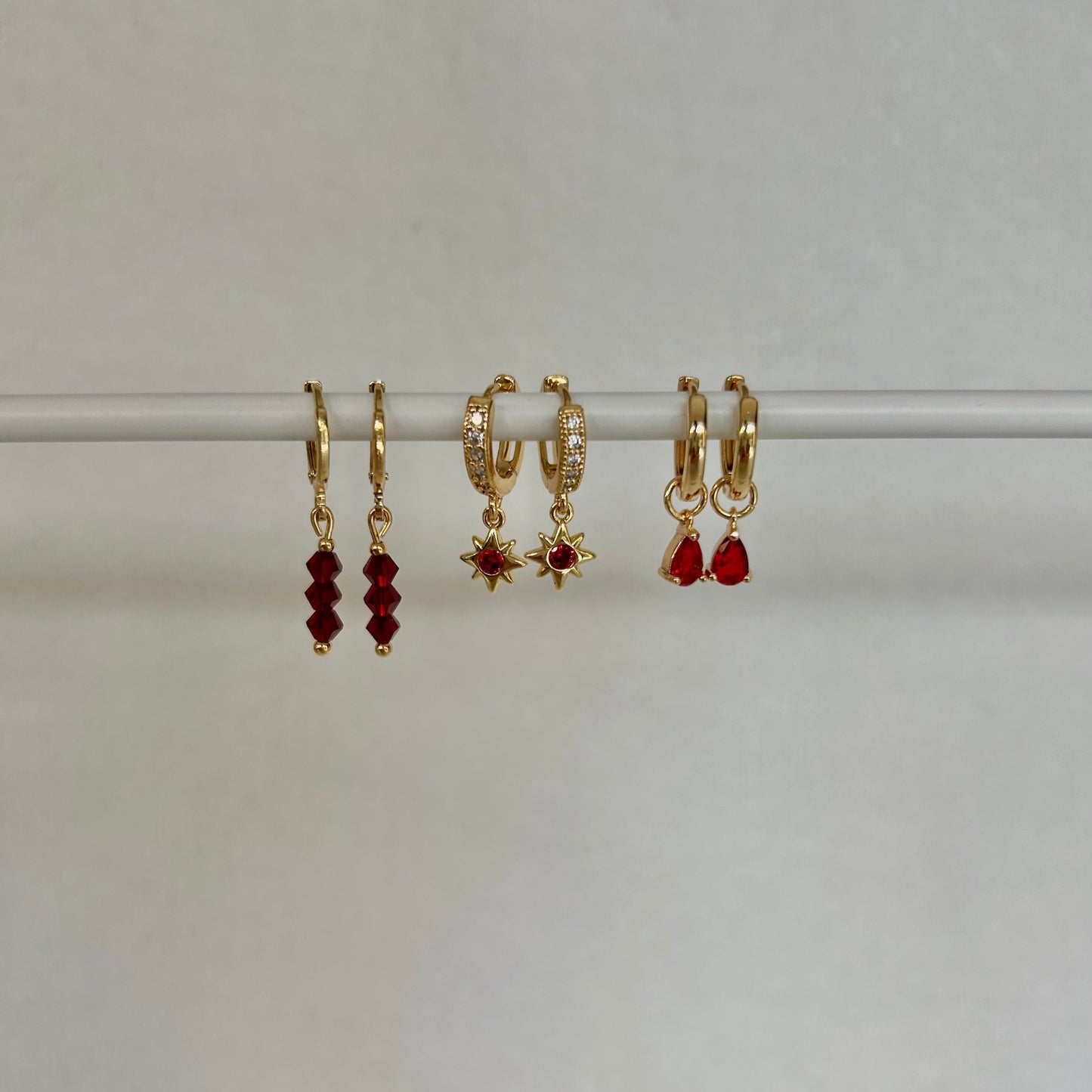 RED STAR HUGGIE EARRINGS IN 18K GOLD