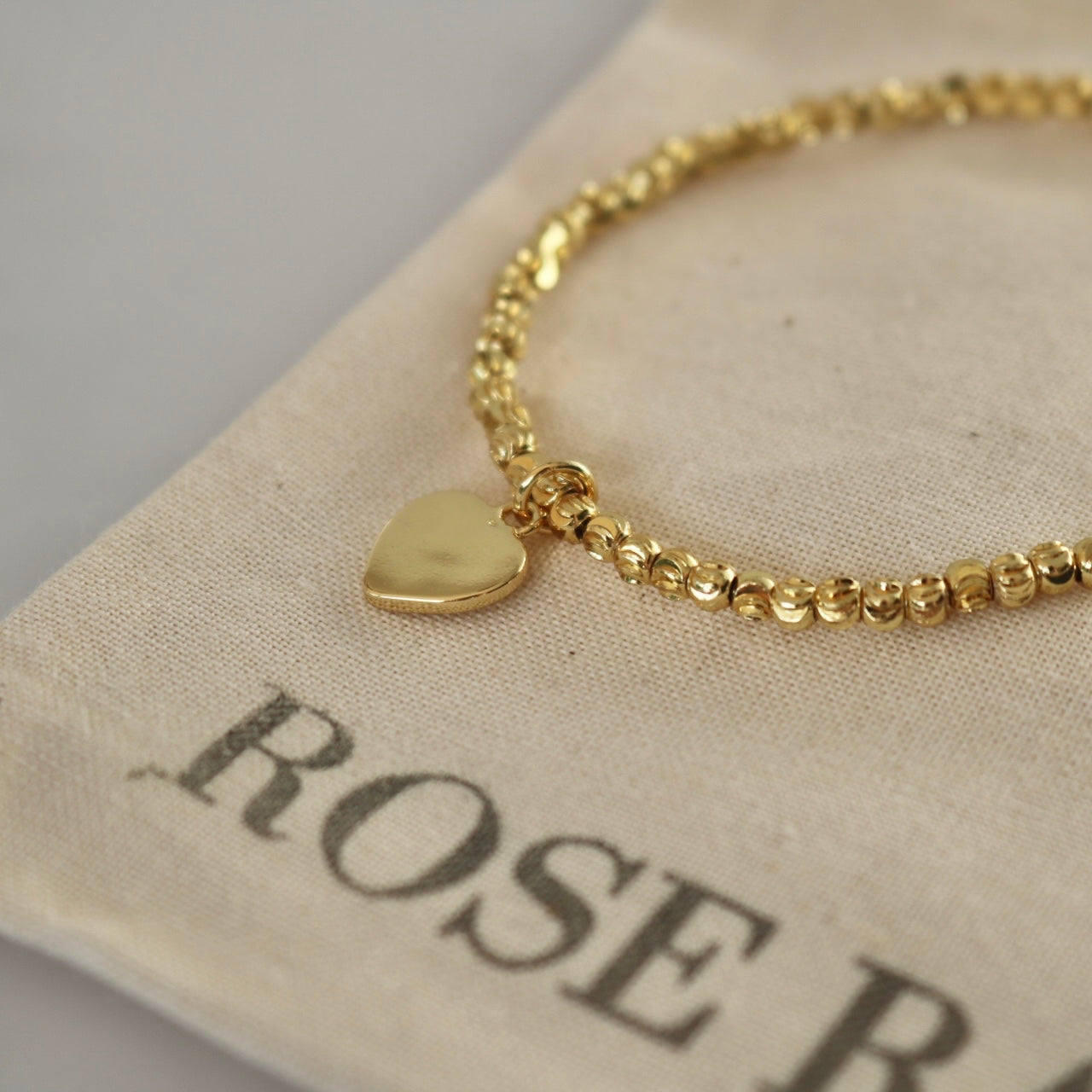 HEART CHARM BRACELET IN 18K GOLD