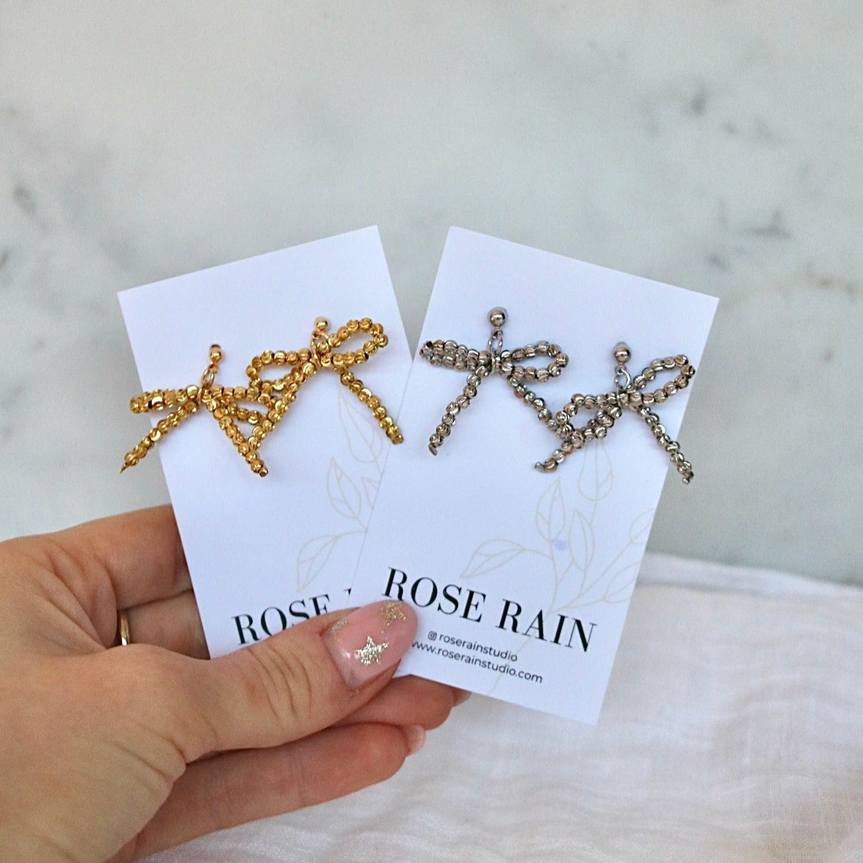 BEADED BOW STUDS IN 18K GOLD