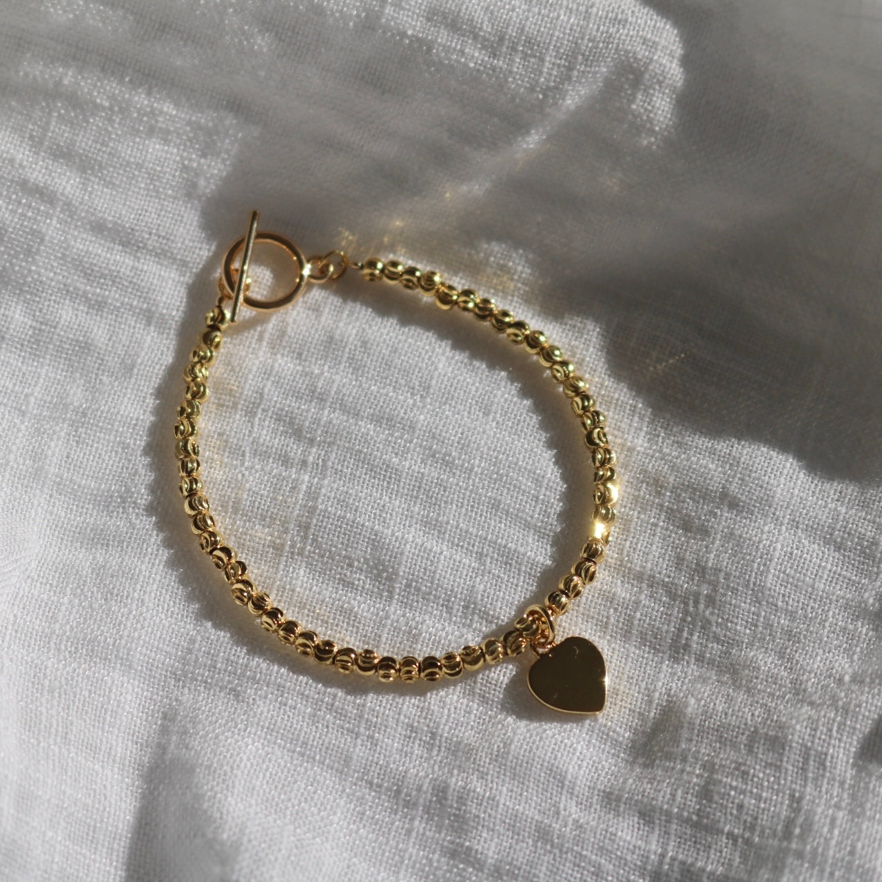 HEART CHARM BRACELET IN 18K GOLD