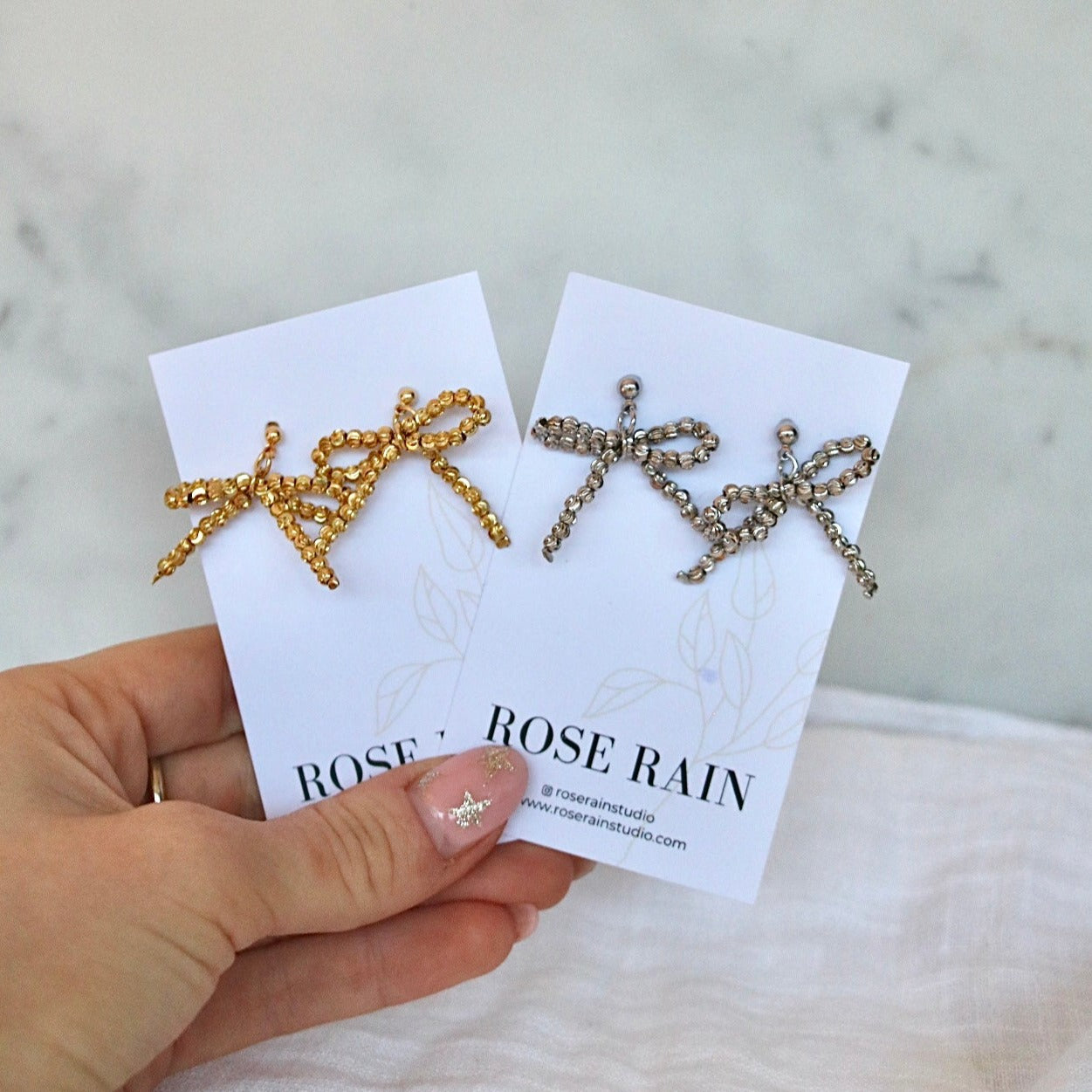 BEADED BOW STUDS IN PLATINUM