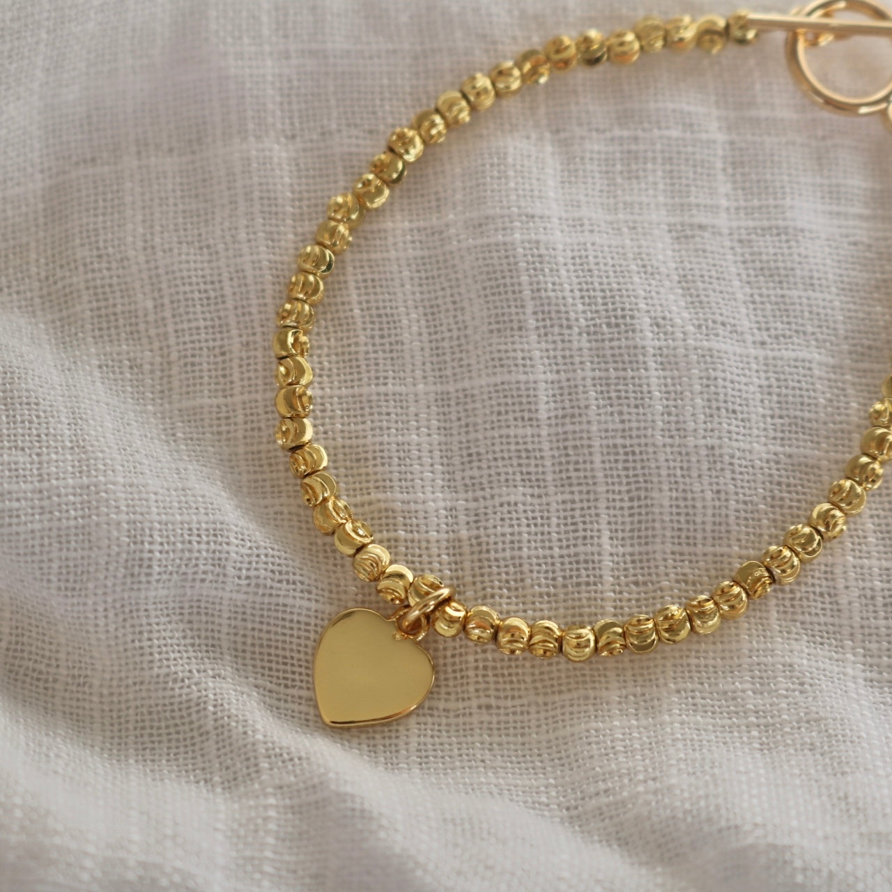 HEART CHARM BRACELET IN 18K GOLD