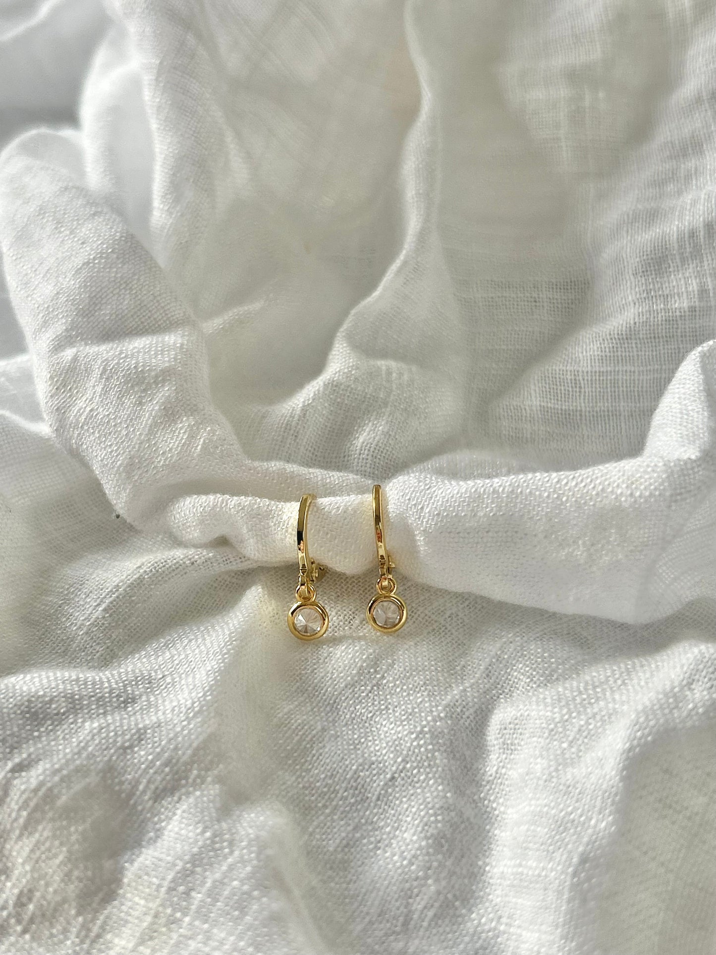 TINY DROP HUGGIE EARRINGS IN 18K GOLD