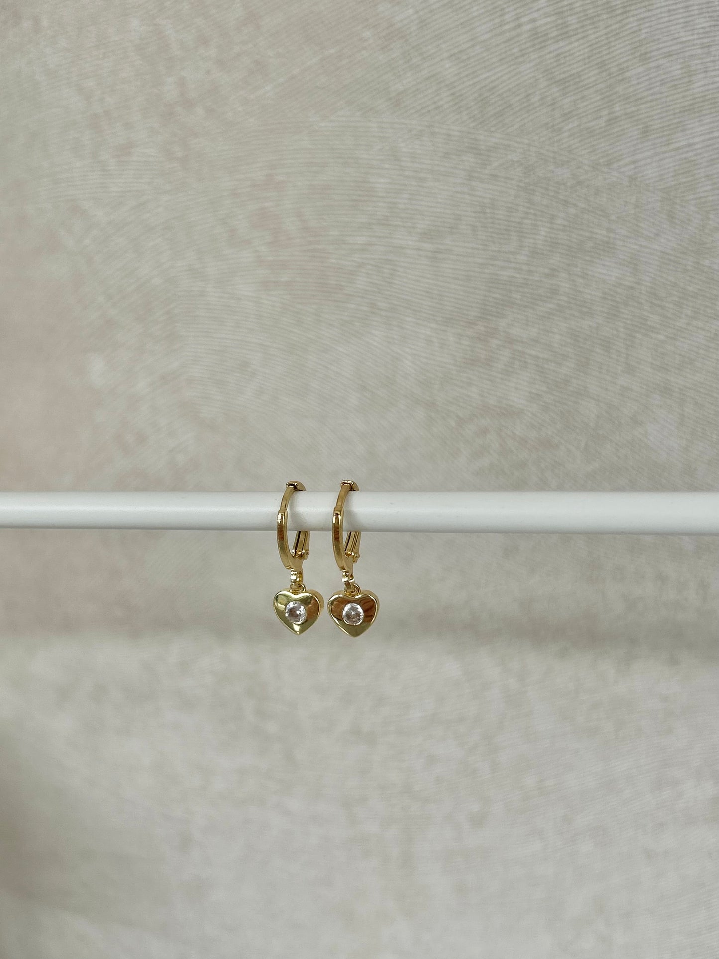 TINY HEART HUGGIE EARRINGS IN 18K GOLD