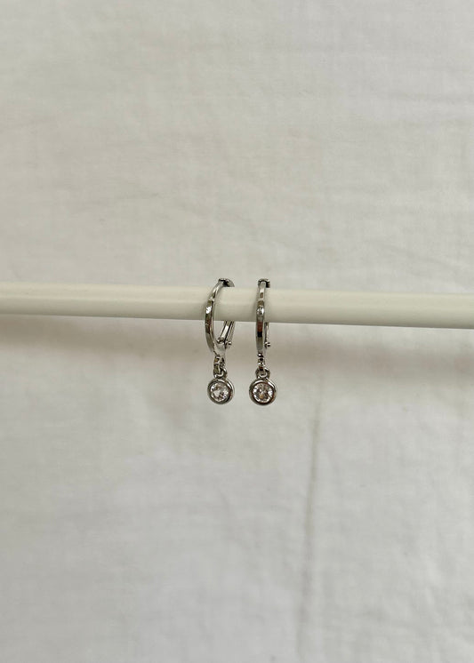 TINY DROP HUGGIE EARRINGS IN PLATINUM