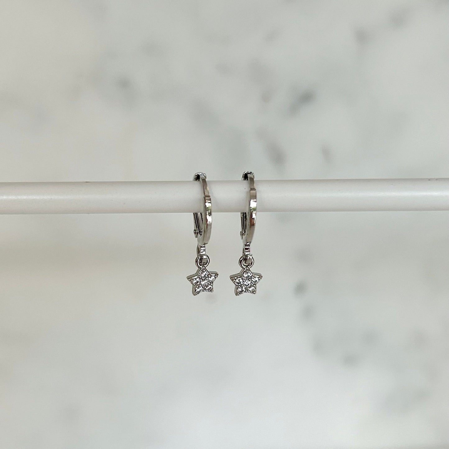 TINY STAR HUGGIE EARRINGS IN PLATINUM