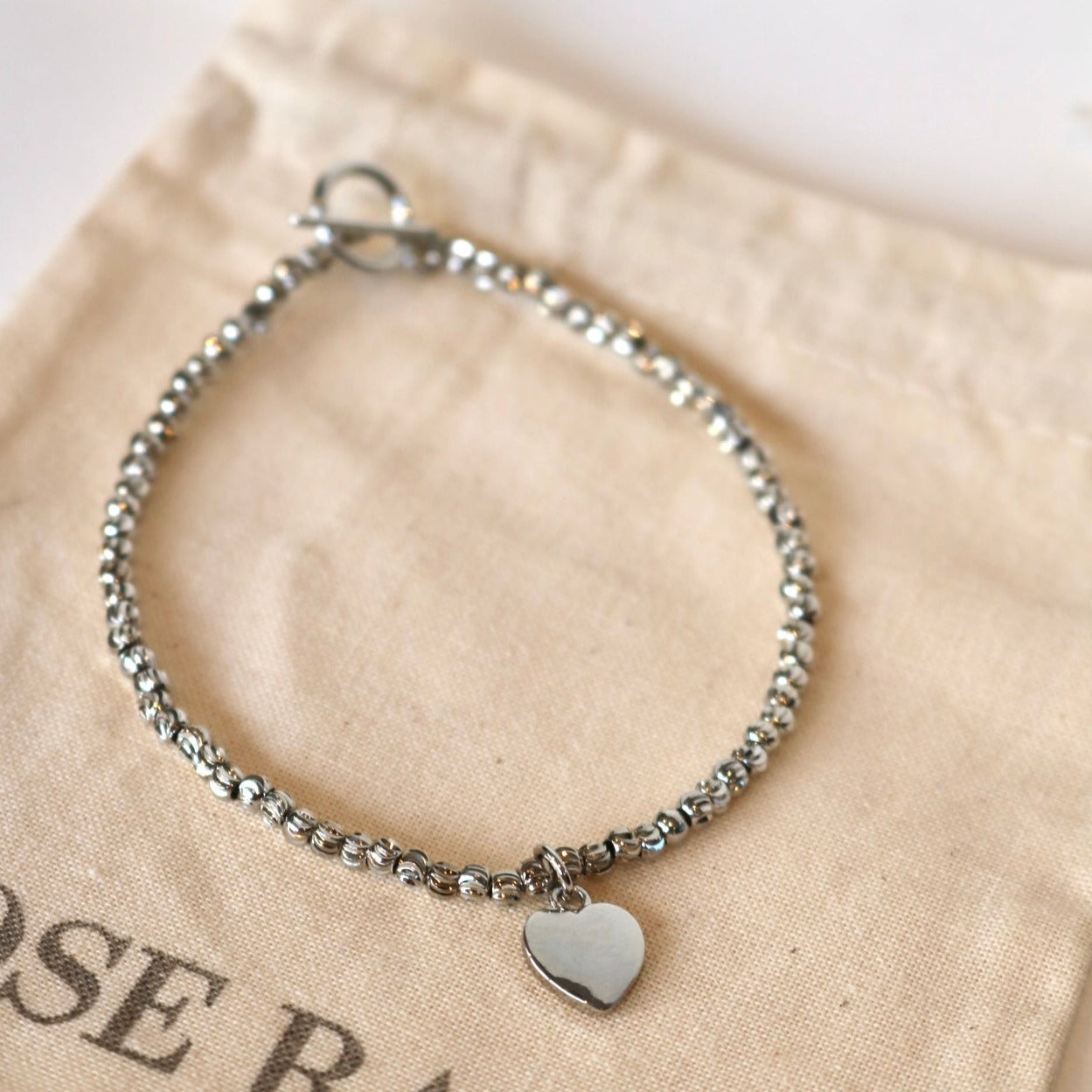 HEART CHARM BRACELET IN PLATINUM