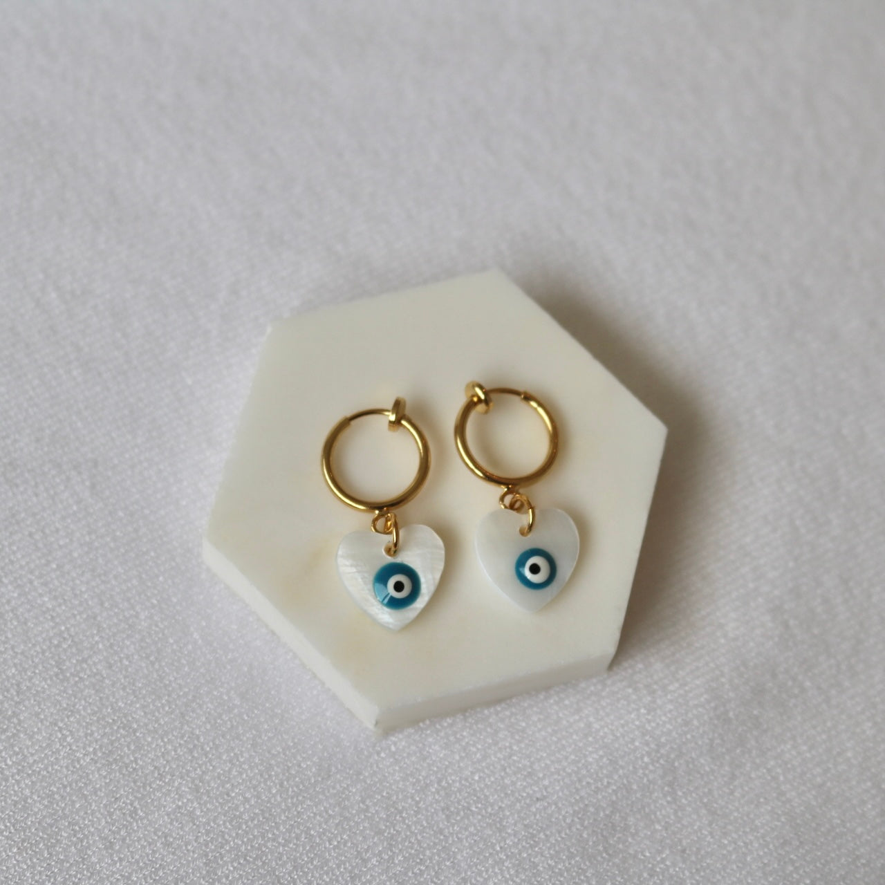 CLIP ON EVIL EYE HEART FRESHWATER SHELL HUGGIE EARRINGS IN 18K GOLD