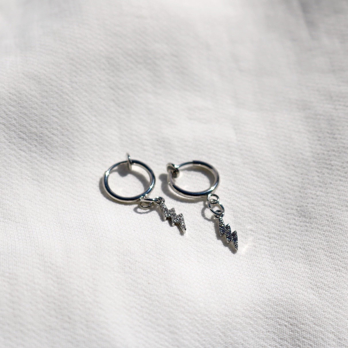 CLIP ON LIGHTNING CHARM HUGGIE EARRINGS IN PLATINUM