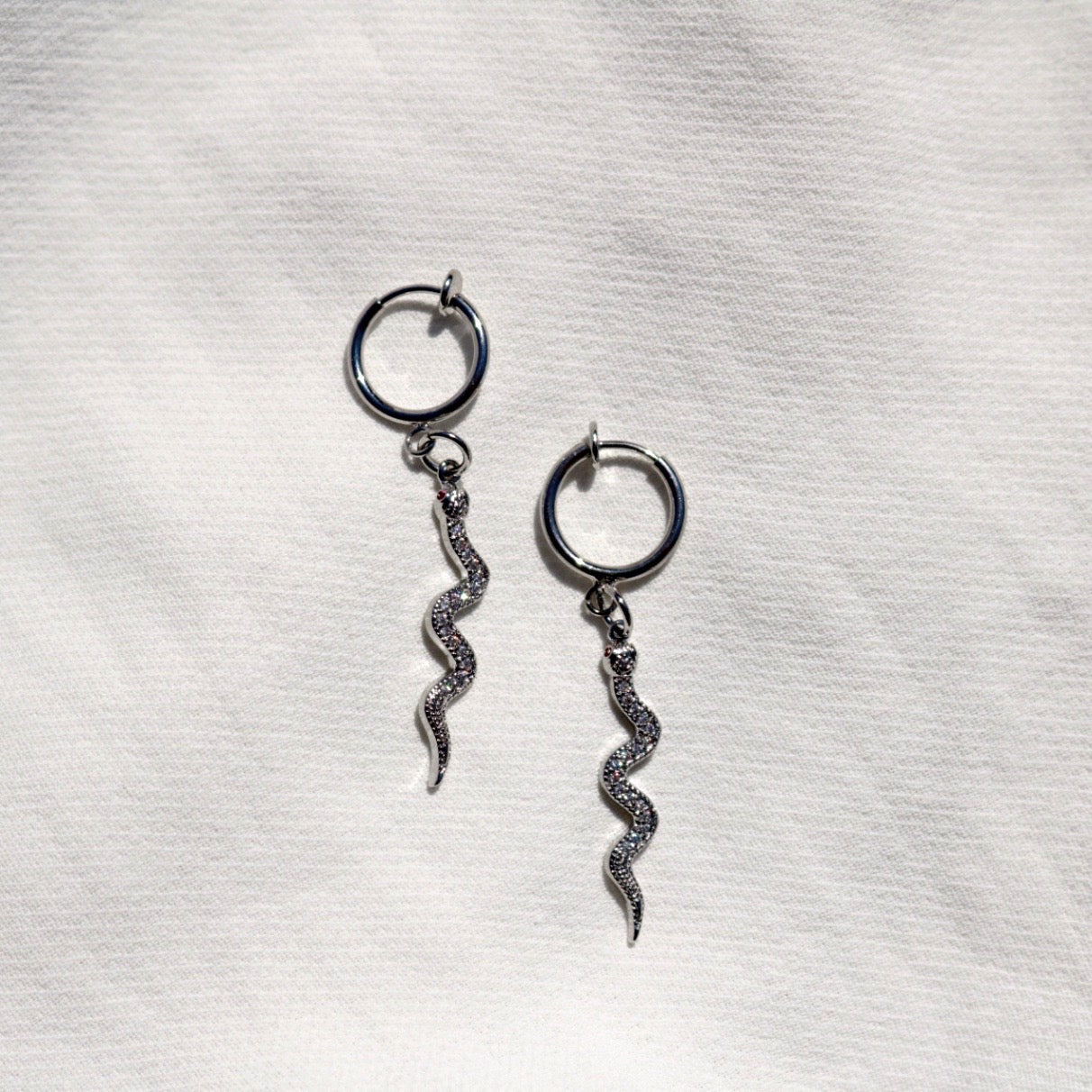 CLIP ON SNAKE CHARM HUGGIE EARRINGS IN PLATINUM